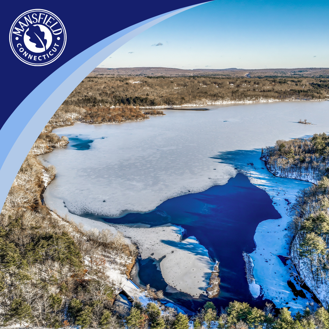 Aerial view of Mansfield Hollow Lake in winter, snow and ice cover most of the water