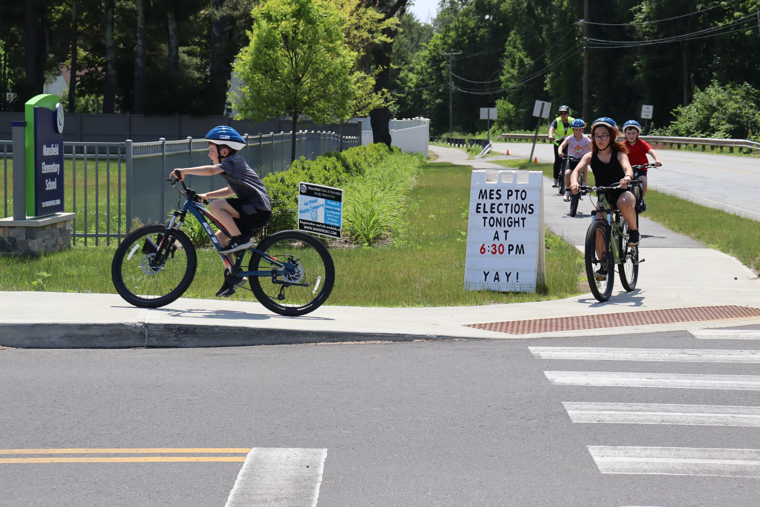Students riding bicycles at MES during the neighborhood ride